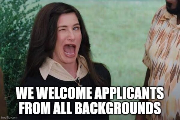 Agnes Harkness from the movie Wandavision (played by Katherine Hahn) winking with the caption "We welcome applicants from all backgrounds" in white block capital text at the bottom of the image.  