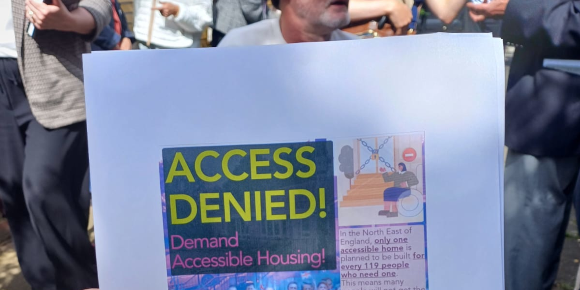 a photograph of a flyer, the test reads "Access Denied! Demand Accessible Housing!"