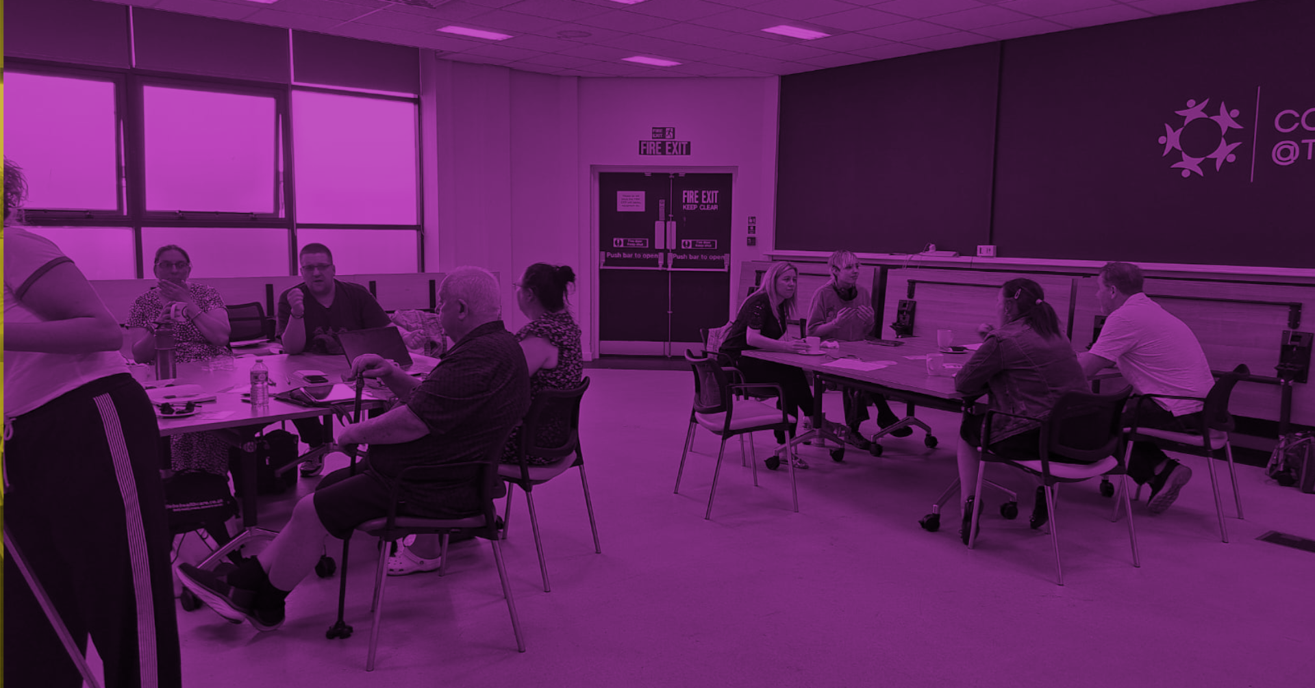 Imagining Accessible Futures: Northern Stage. A group of Difference North East members sitting together in a bright room, everyone appears relaxed and connected. The image has a purple colour overlay, reflecting the colour of the disability movement
