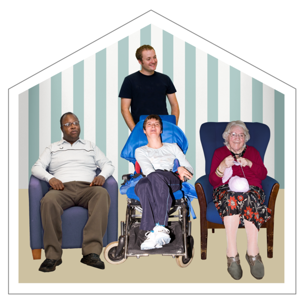 Four people are in a room. A man sits in an armchair, a person is in a wheelchair, and a woman is knitting. Another man stands behind them. The setting is cosy and home-like.